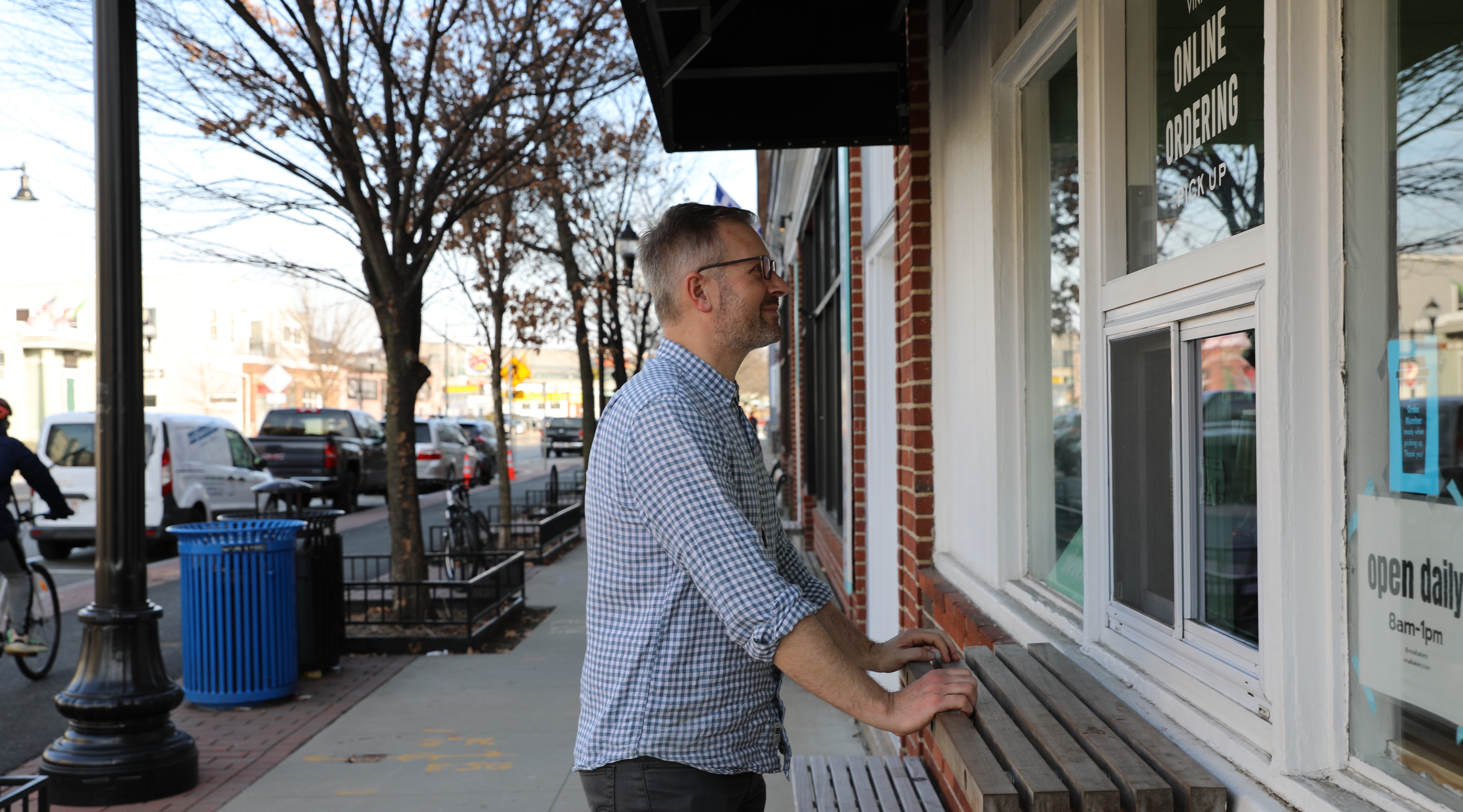 Jake rests outside of Vinal General Store and looks through the windows