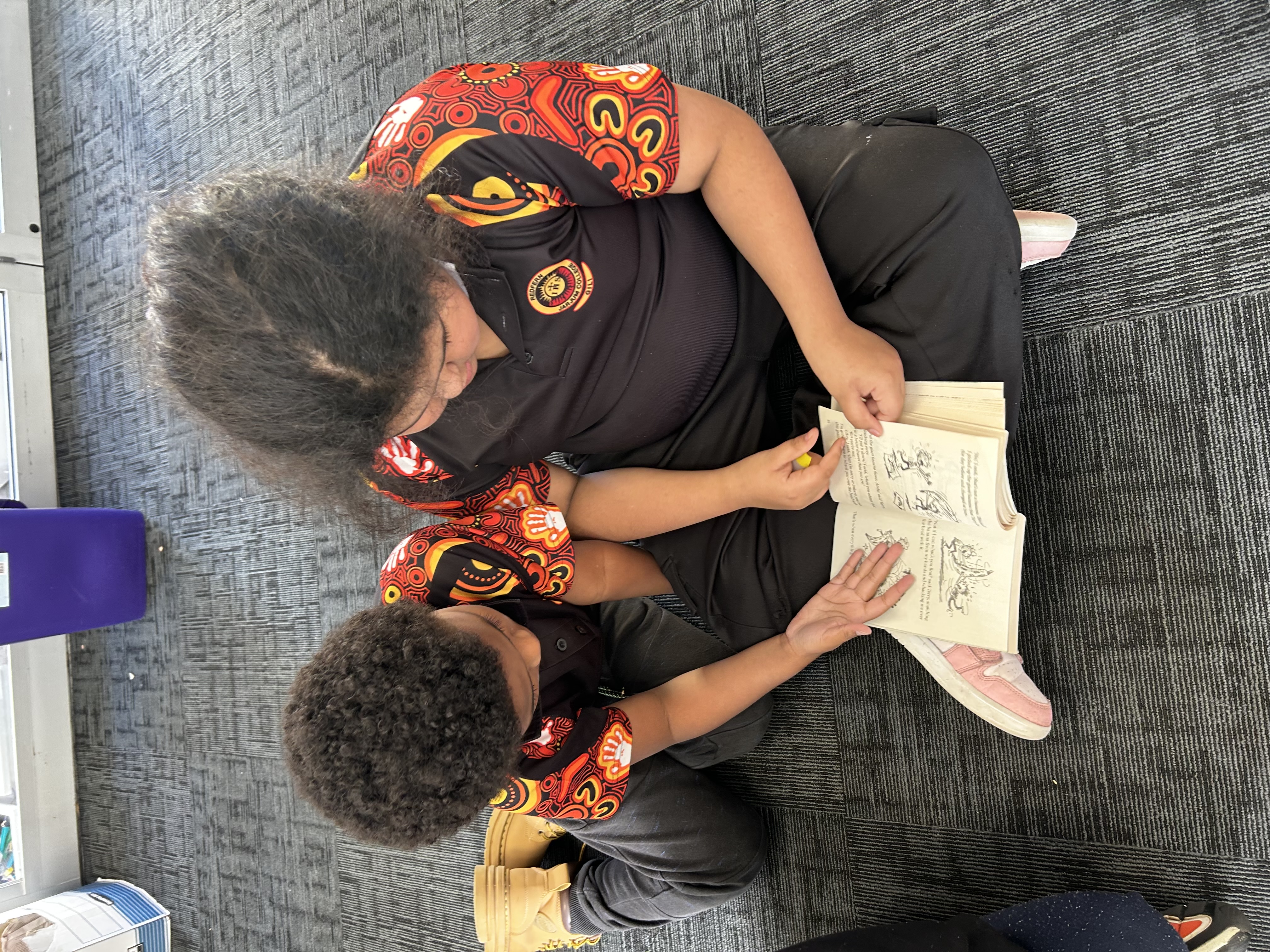 Two Jarjum students reading a book together