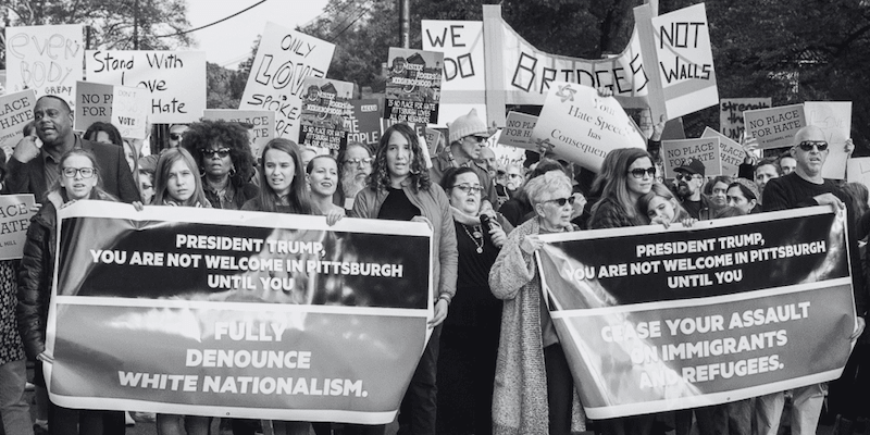 Photograph of marchers in Pittsburgh holding signs that say
President Trump is not welcome until he dencounces white nationalism