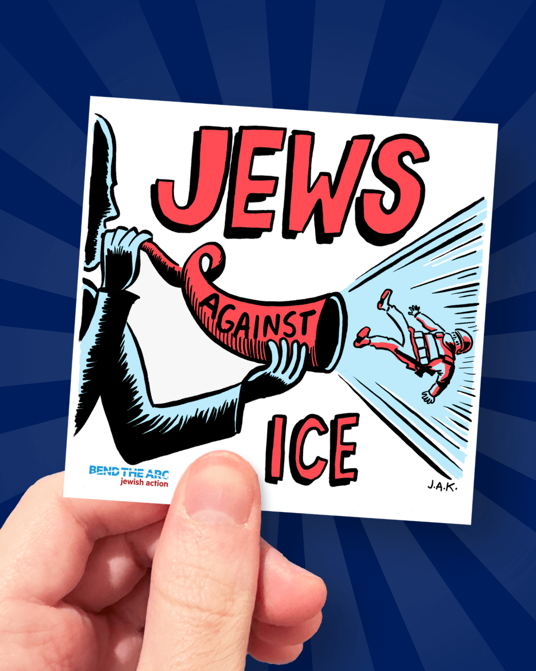 Hand holding the new Jews Against ICE sticker