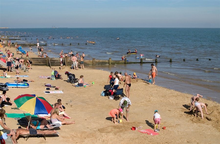 Families on the beach at Frinton-on-Sea on a summer afternoon