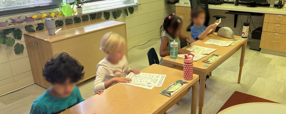 Children working independently at desks in the classroom