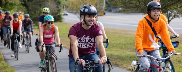 people biking together on a path separated from the road