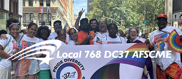 Image of DC37 members with their banner marching on May 1 in NYC