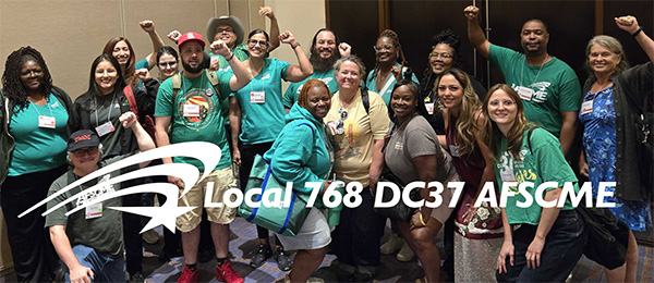 Image of DC37 members with their banner marching on May 1 in NYC