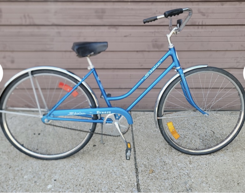 An old-school blue Schwinn bike with 3 gears and fenders