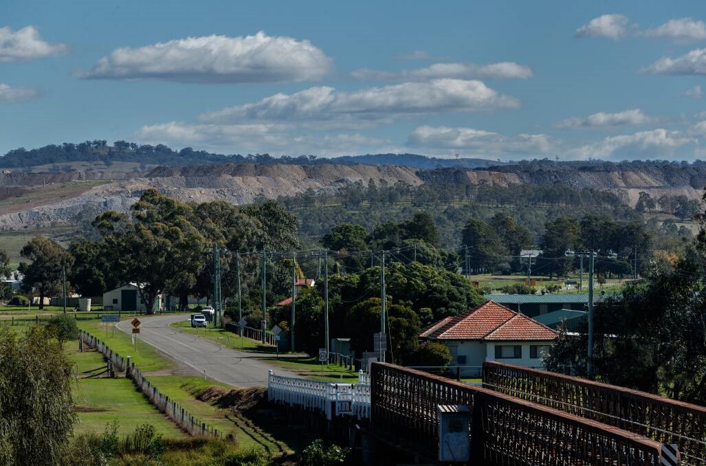Piles of tailings from Mount Pleasant mine loom over the outskirts of Muswellbrook. Picture by Max Mason-Hubers