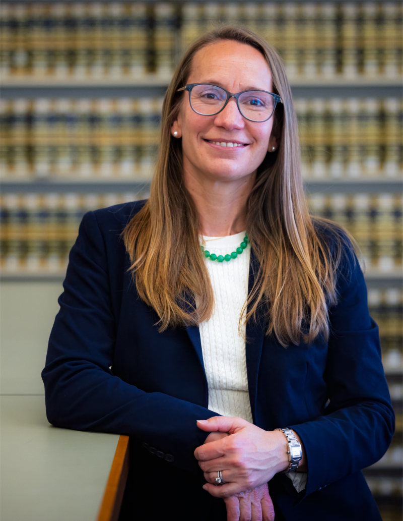 Phoebe_Maffei_in_Law_Library_leaning_on_bookcase_mobile.jpg