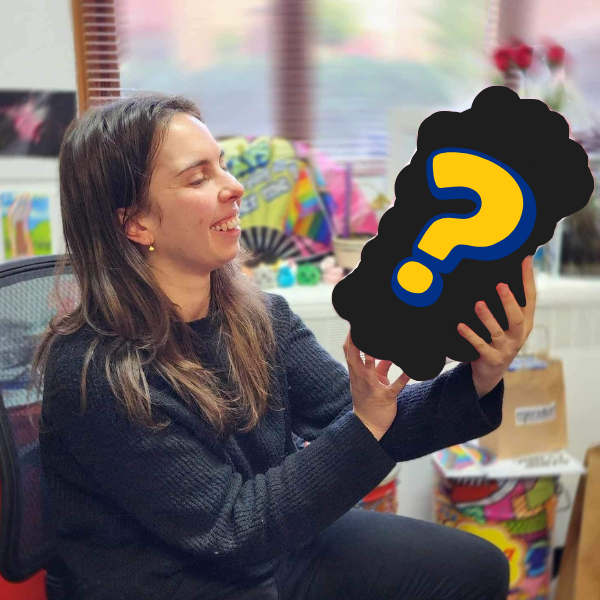 Image of a person holding an object around the size of two basketballs that has been blacked out, with a question mark over the top