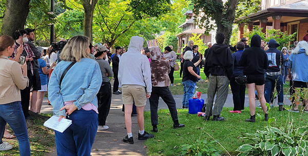 crowd looking at house