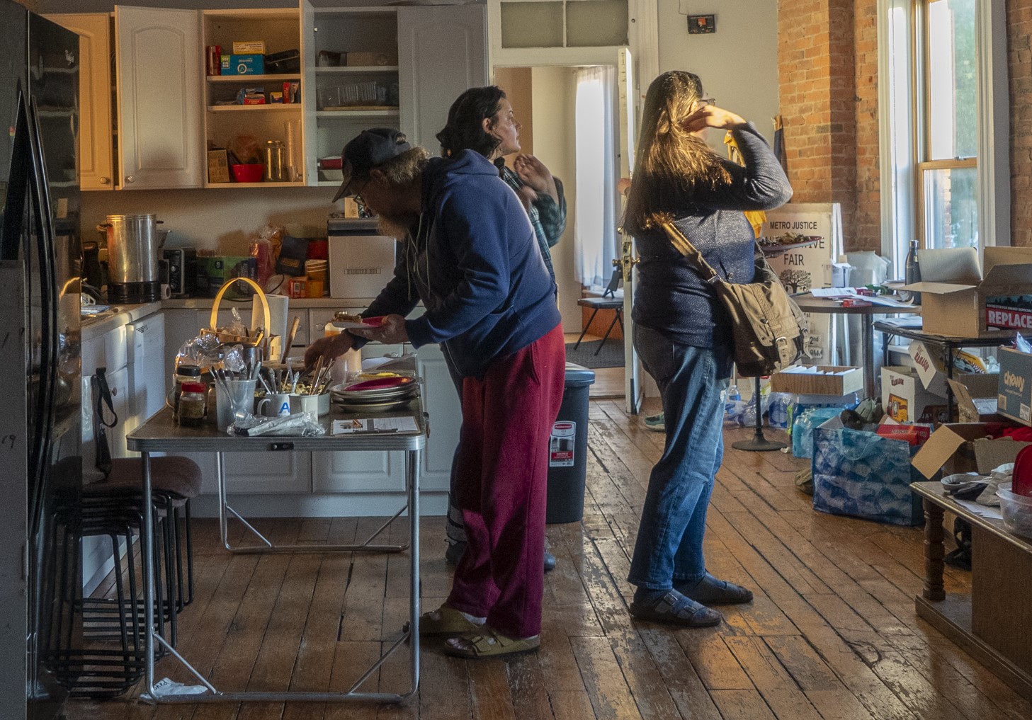 people at potluck serving table