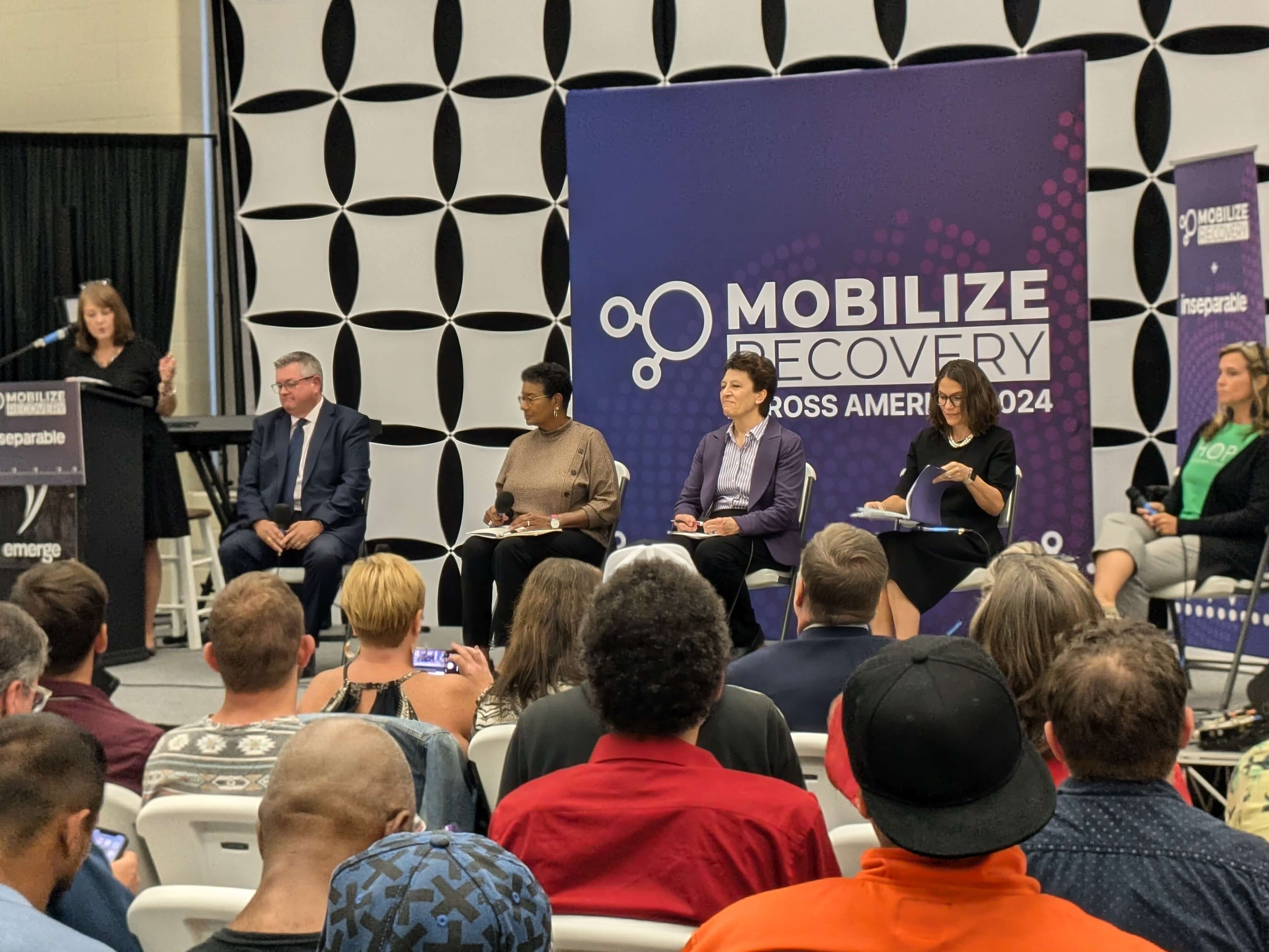 Panelists seated on stage during the Dayton, Ohio Mobilize Recovery event