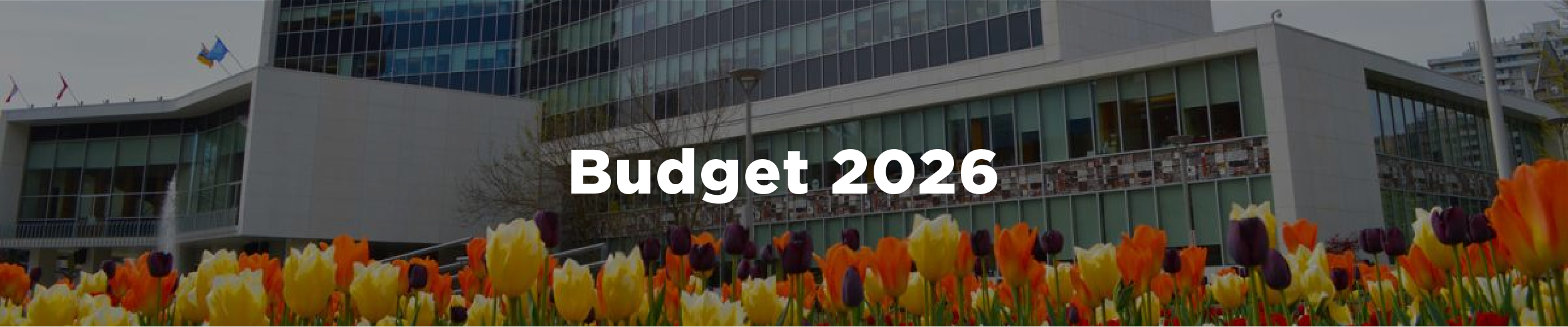 Hamilton City Hall in the springtime featuring colourful tulips with the overlaid text "Budget 2026"