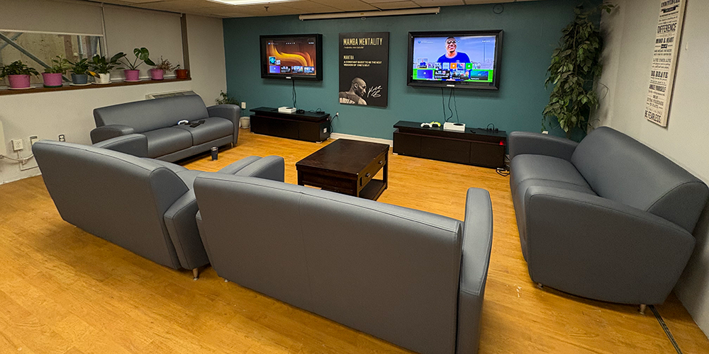 A larger image of the couches, set up in a "U" to facilitate conversation and to allow the youth in the program a chance to watch TV, socialize, and have fun in a safe "third space"