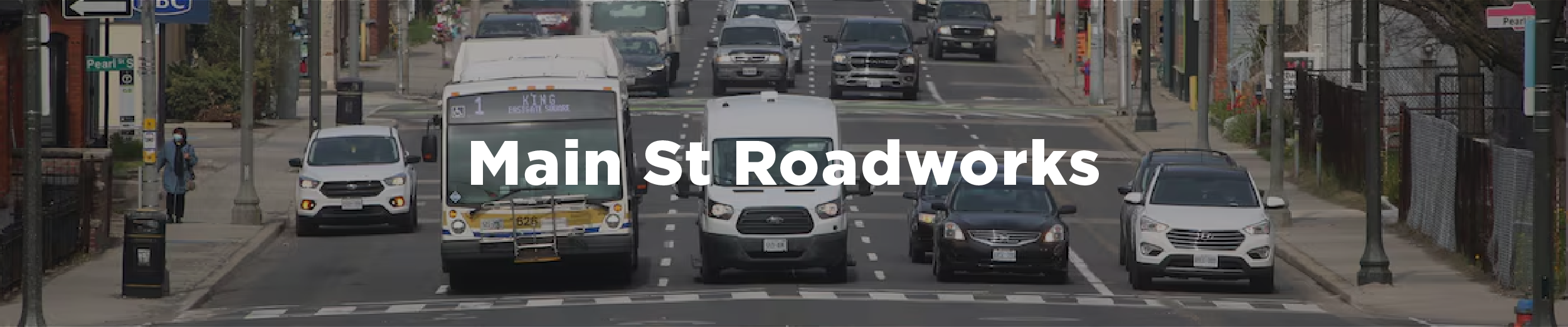 An image of cars lined up at a stop sign along Main St at Pearl St with the overlaid text "Main Street Roadwork"