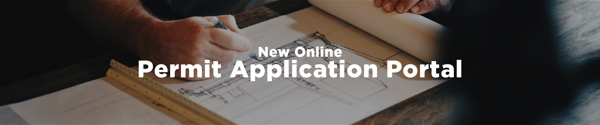 A male hand holding a pencil over a planning document with the overlaid text "New Online Permit Application Portal"