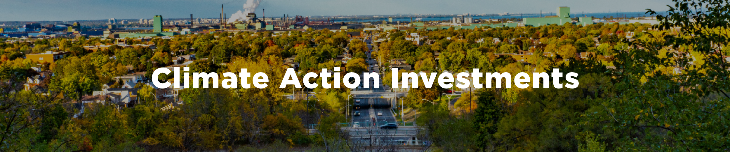 A photo of the Kenilworth Access in the very early fall with the city stretched out before the photographer with the overlaid text "Climate Action Investments"