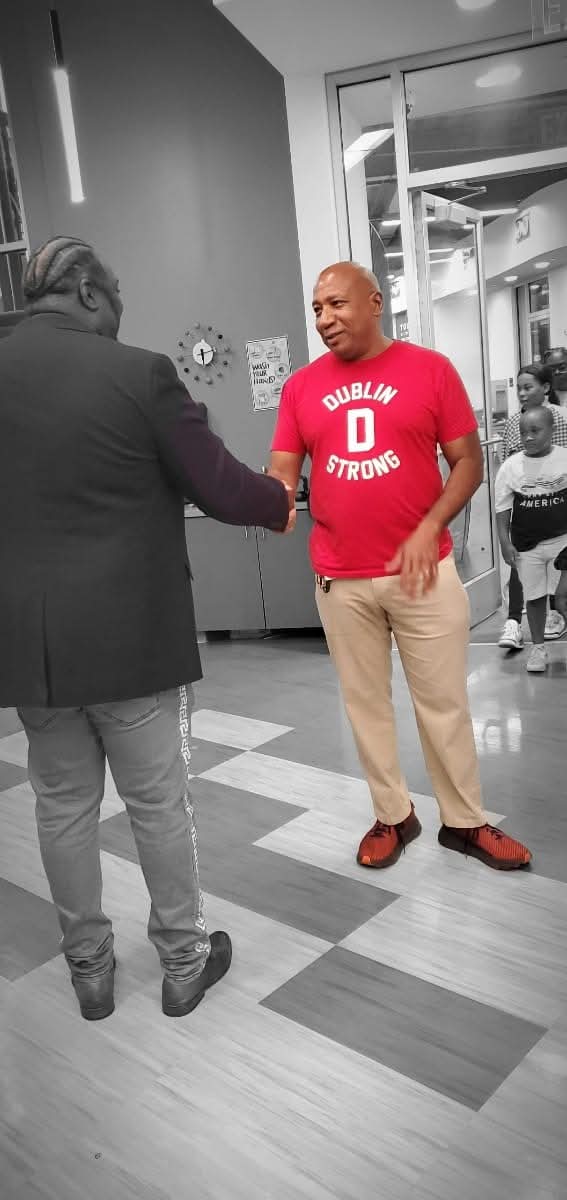 Michael Dublin shaking hands with a supporter