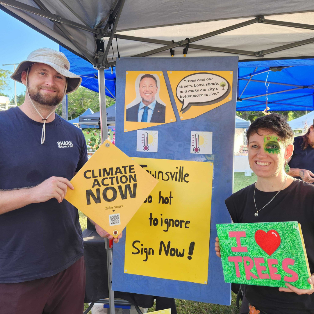 People holding climate signs at the market