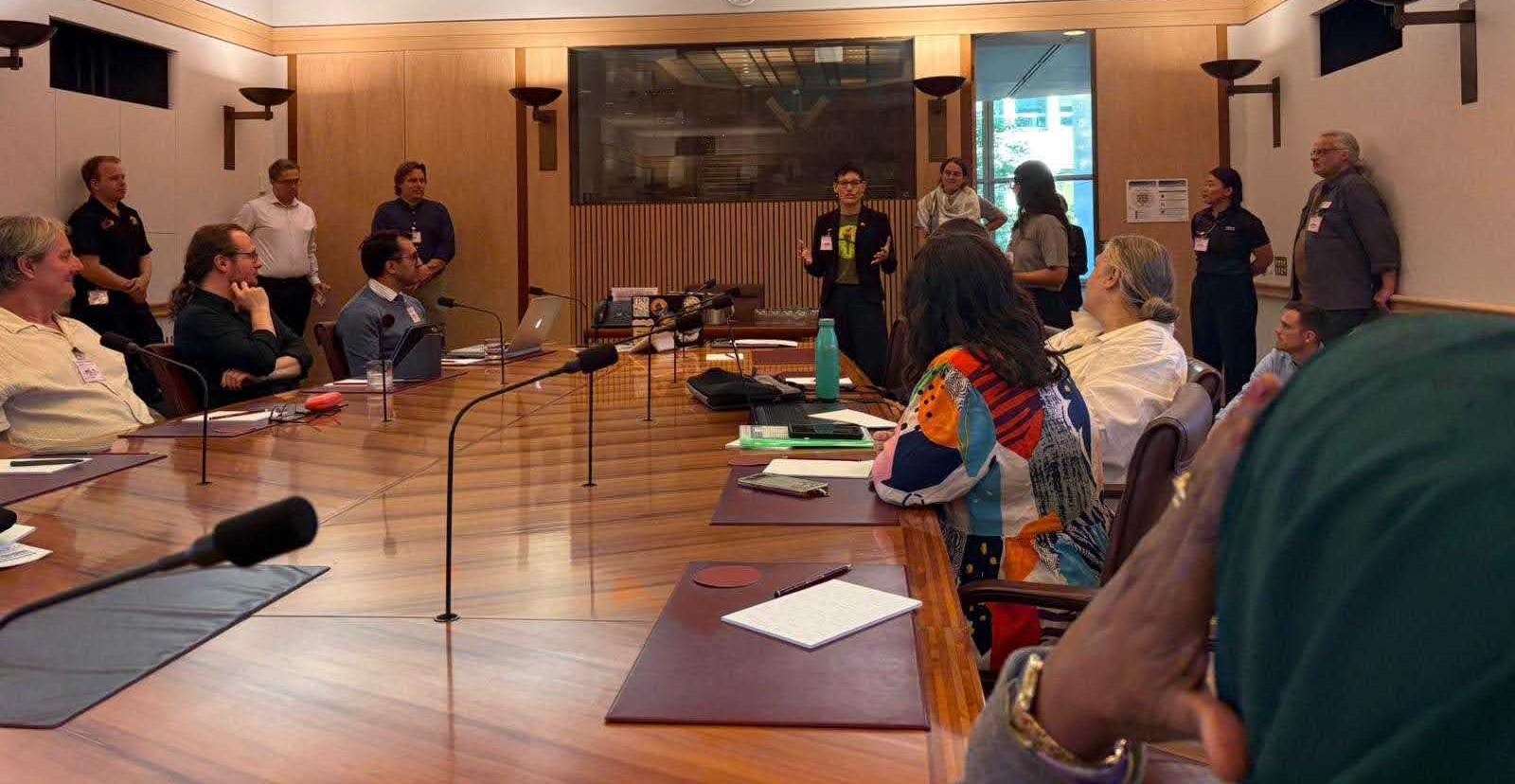 Renew Australia for All delegates sit around a table at a briefing