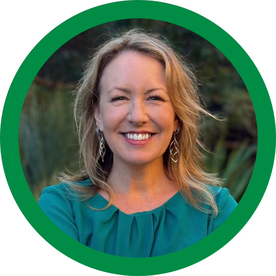 headshot photo of Abigail Boyd smiling wearing a green dress with a green background