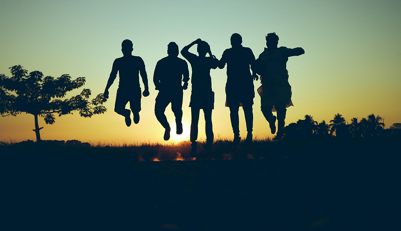 Silhouette of people jumping