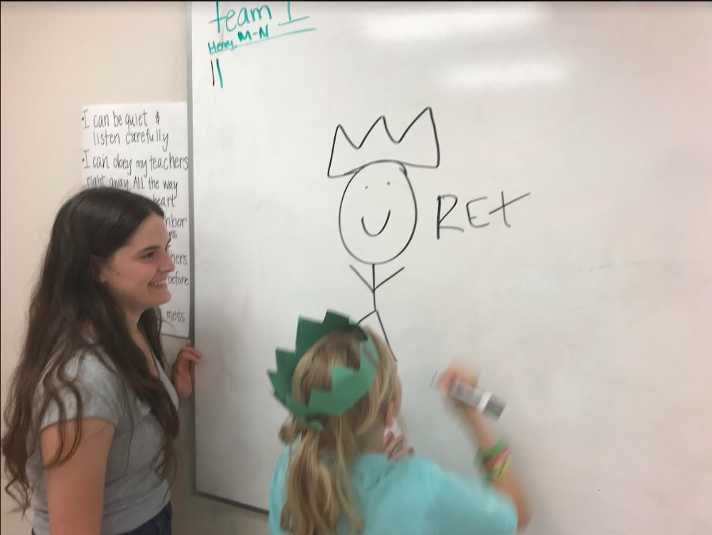 Volunteer helping a student at the board - rex
