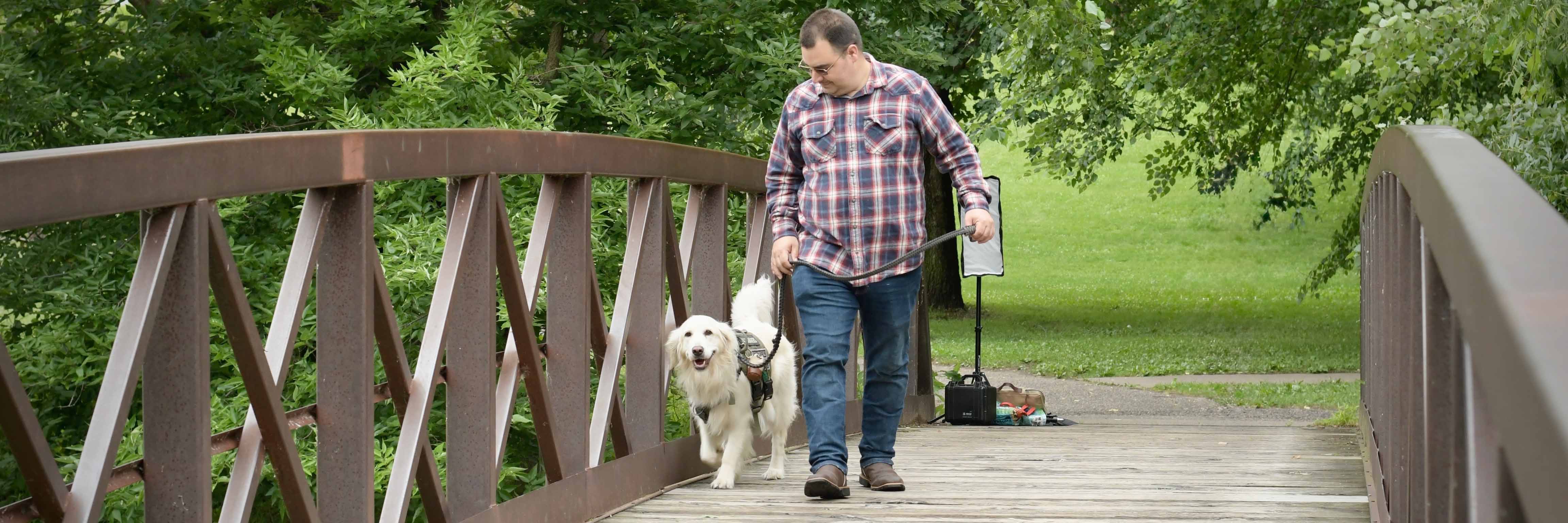 Veteran with service dog on bridge