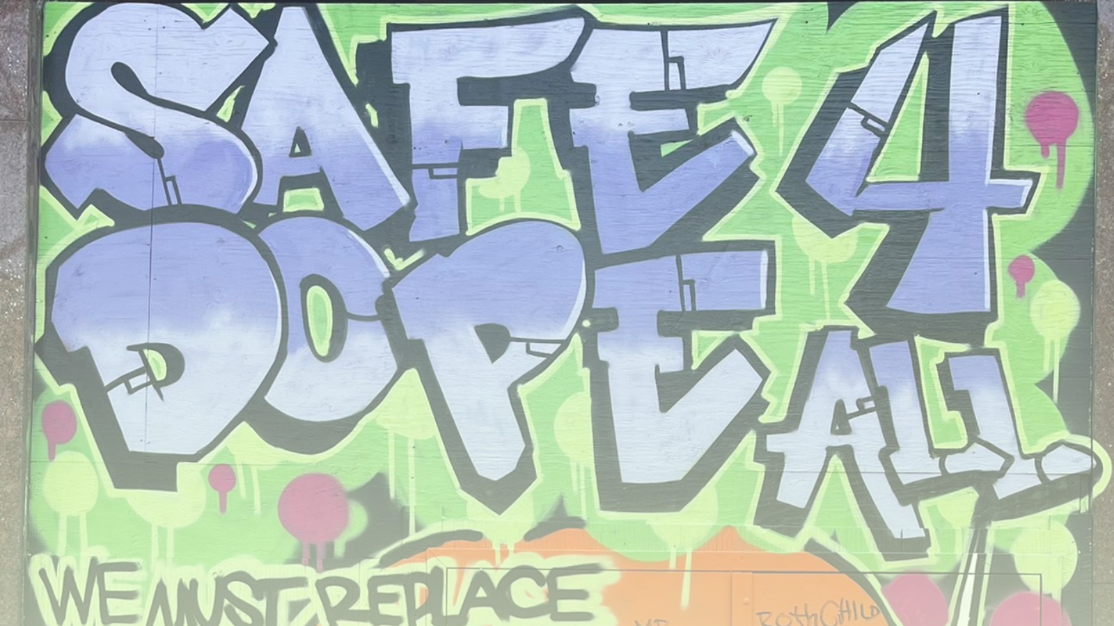 Close-up photo of a graffiti piece by Smokey D and Grow Up at 312 Main. Text: “Safe Dope 4 All.”  
