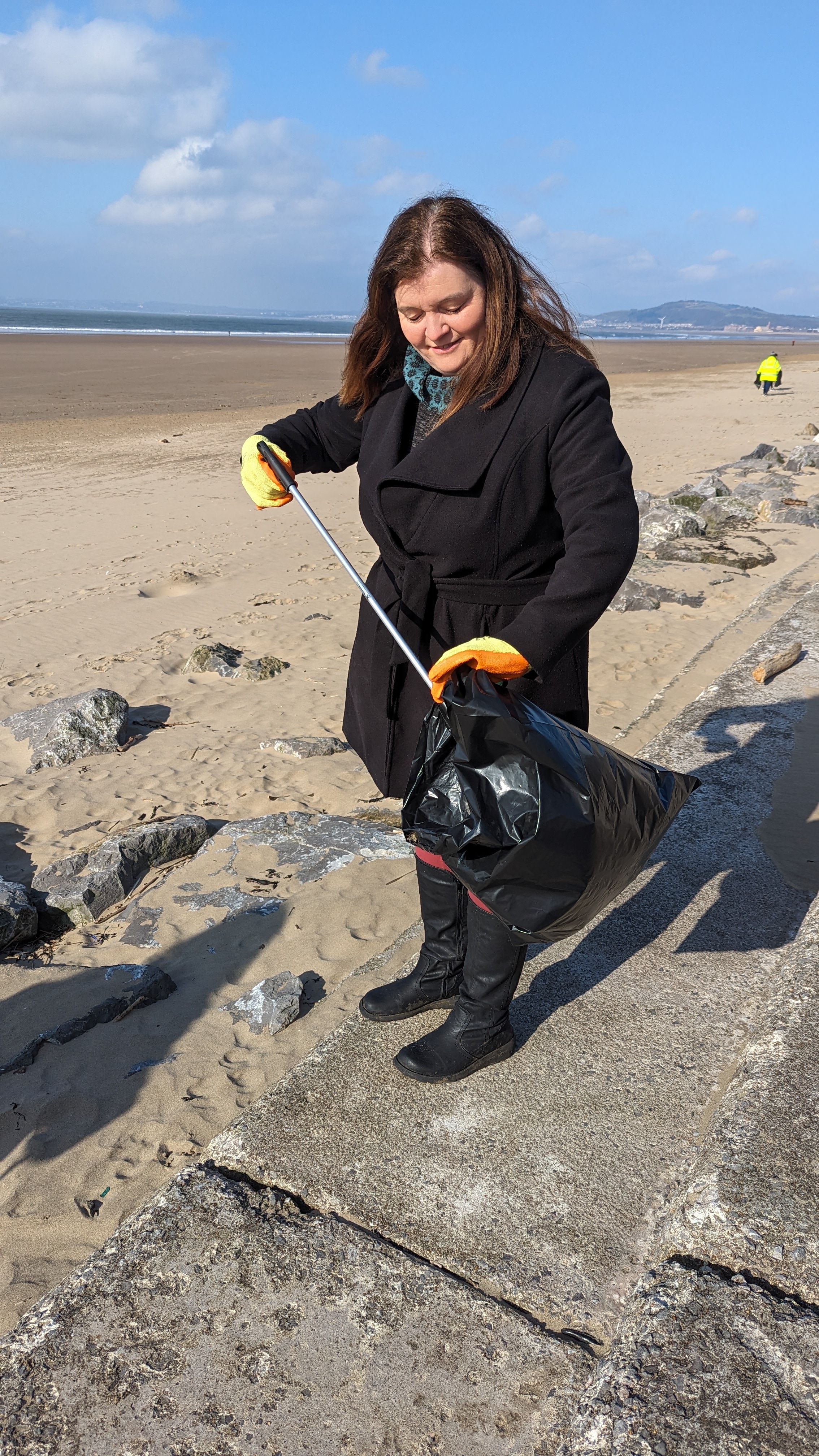 Sioned picking litter on the beach