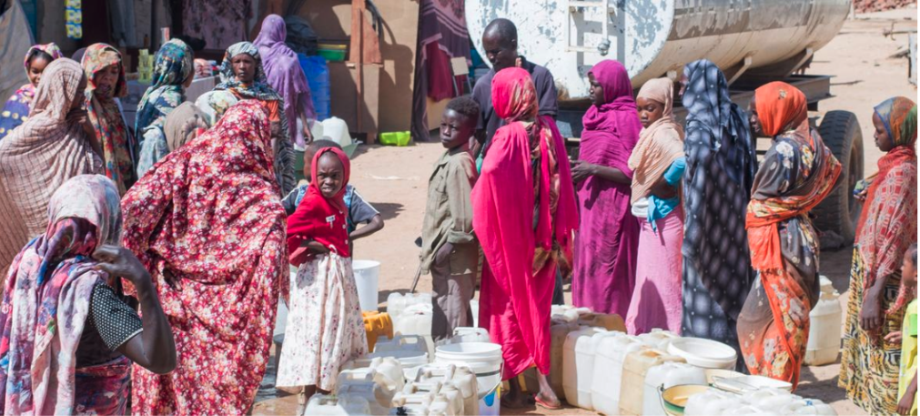 Children and women collect clean and safe water in central Darfur.