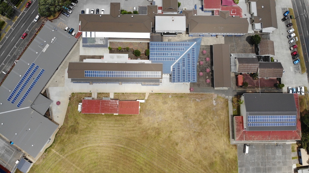 birds eye view of solar panels on school roofs. 