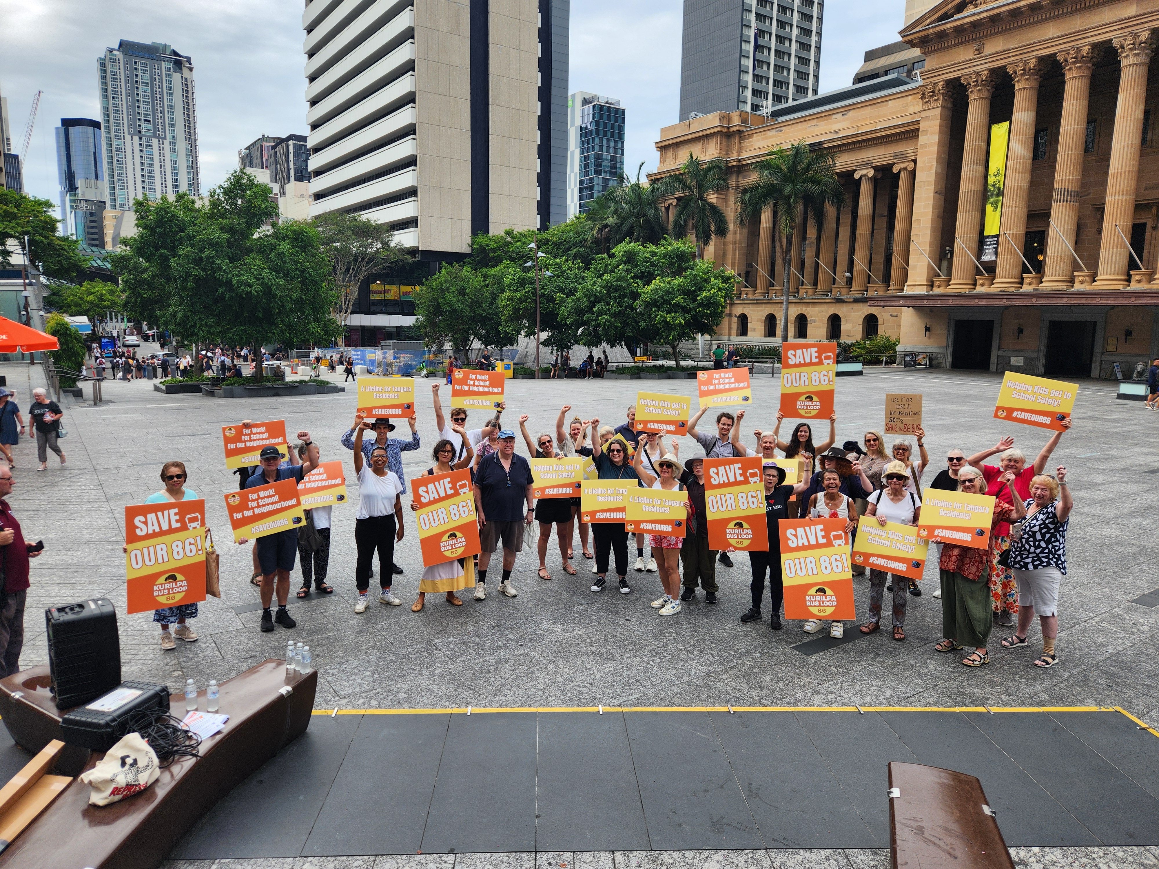 photo of Trina and 86 bus campaigns in front of city hall