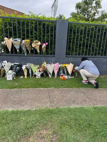 photo of Trina laying flowers at a local synagogue