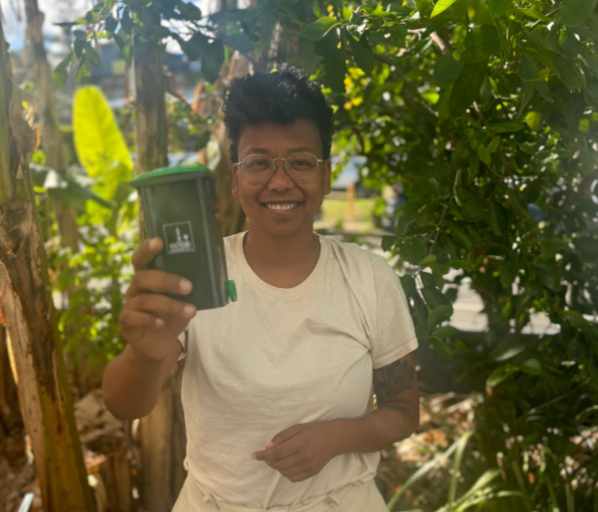 image of Trina with a mini green bin in the Gabba Ward office garden