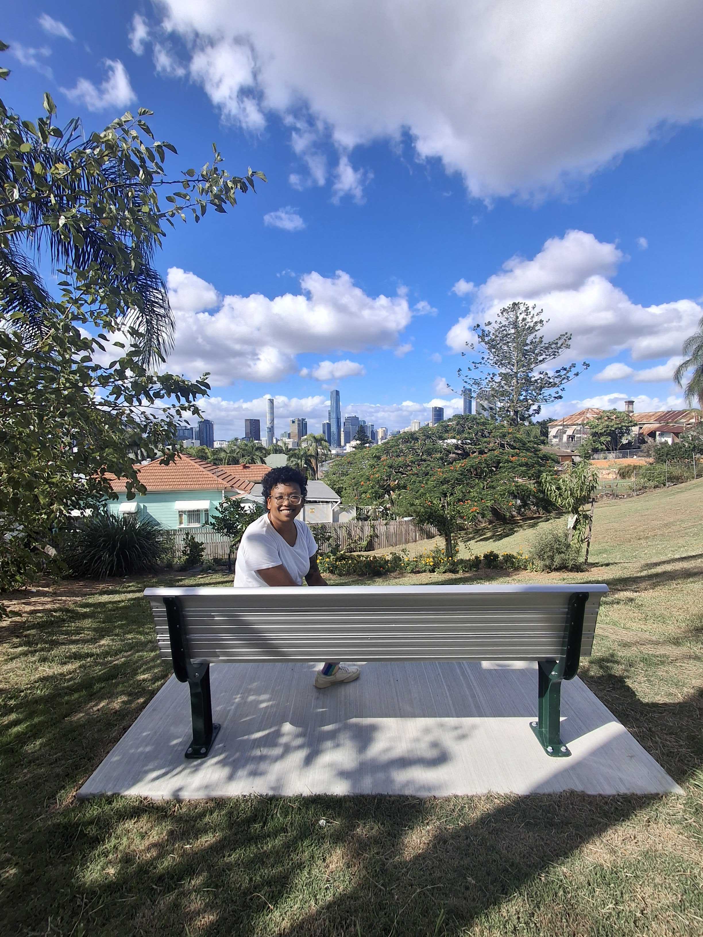 photo of Trina sitting on new bench at Highgate hill park