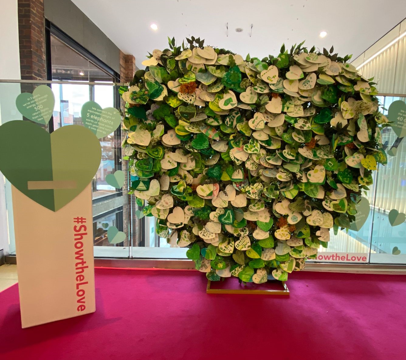 Caption: In Guilford, 3000 green hearts with personal messages from students and residents displayed at The Friary Centre shopping centre; Credit: The Friary Centre