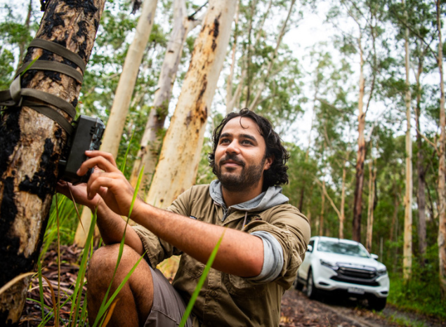 Minyumai Ranger Sylas McElligott sets up a night camera. Photo: Annette Ruzicka.