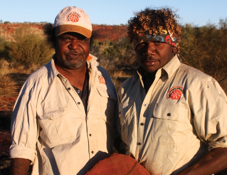 Copy_of_Jigalong_rangers_with_a_grind_stone_found_after_burning_country_(1).jpg