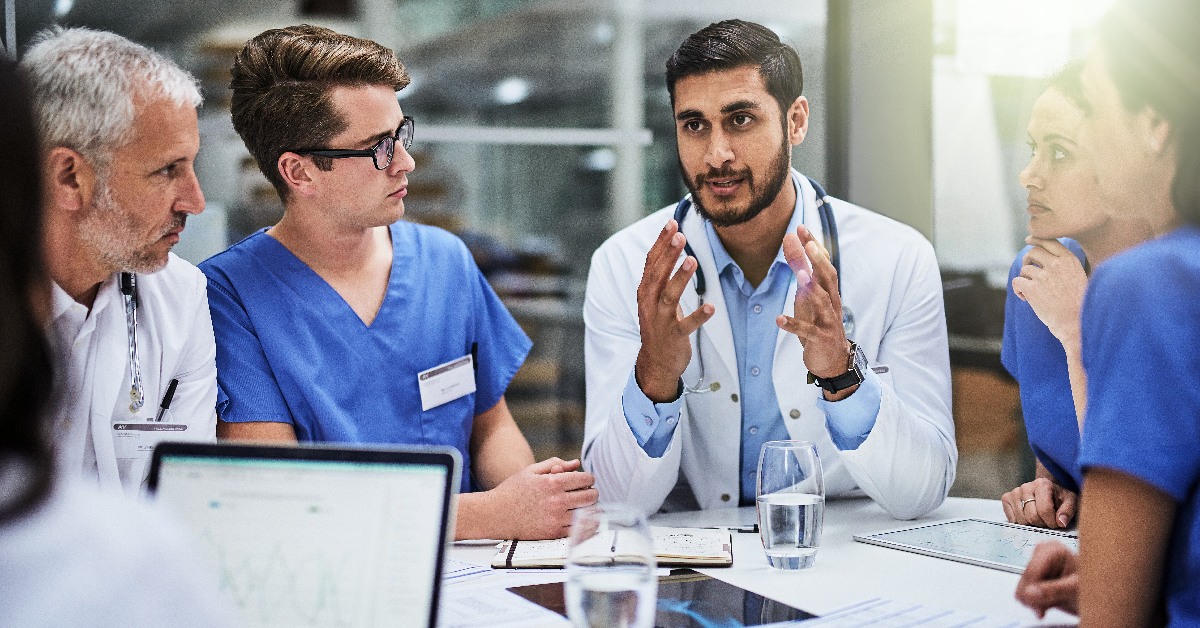Six medics in discussion.