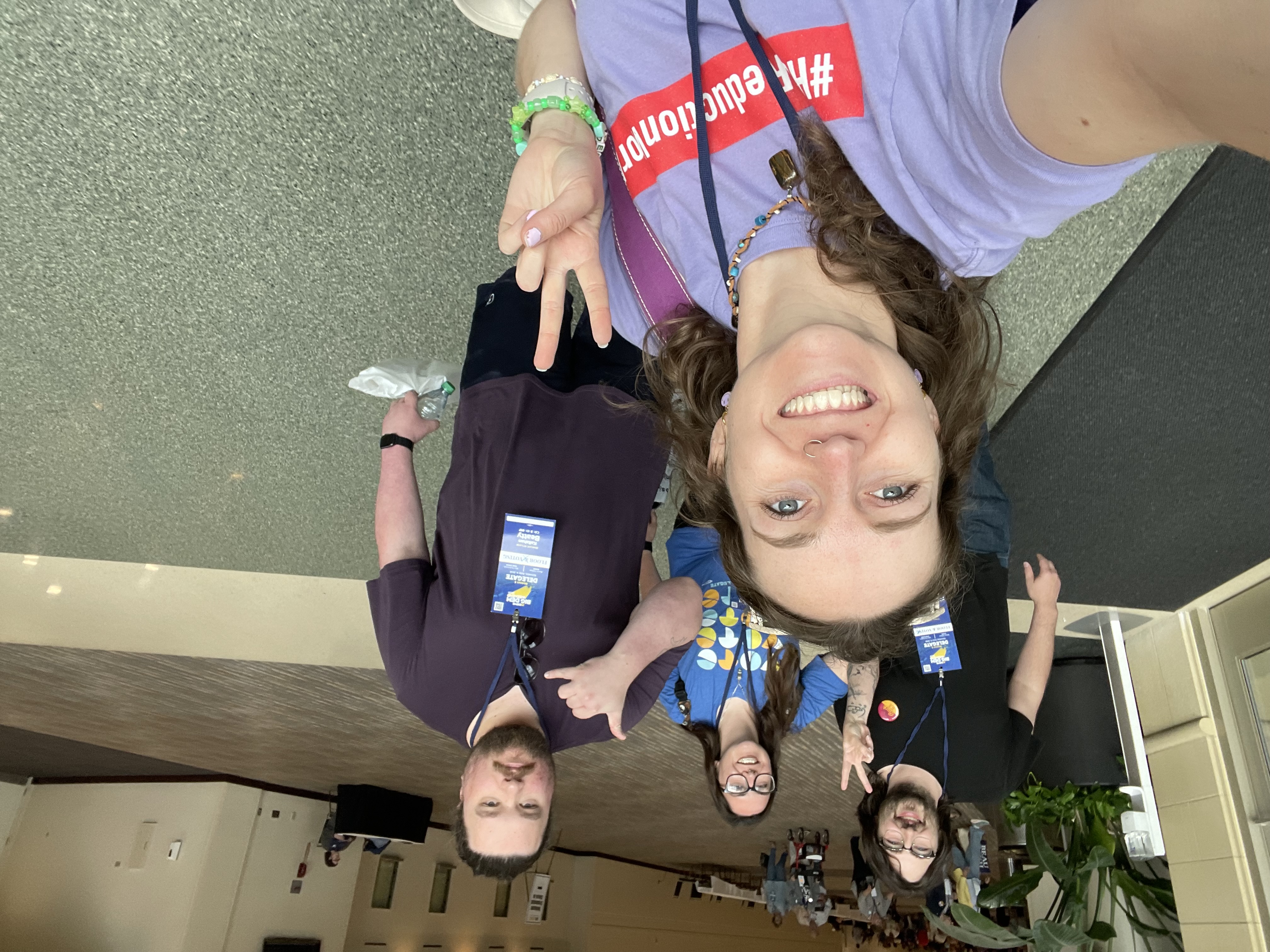 Bethany Wenger takes a selfie with three fellow Howard County delegates in a convention center hallway.