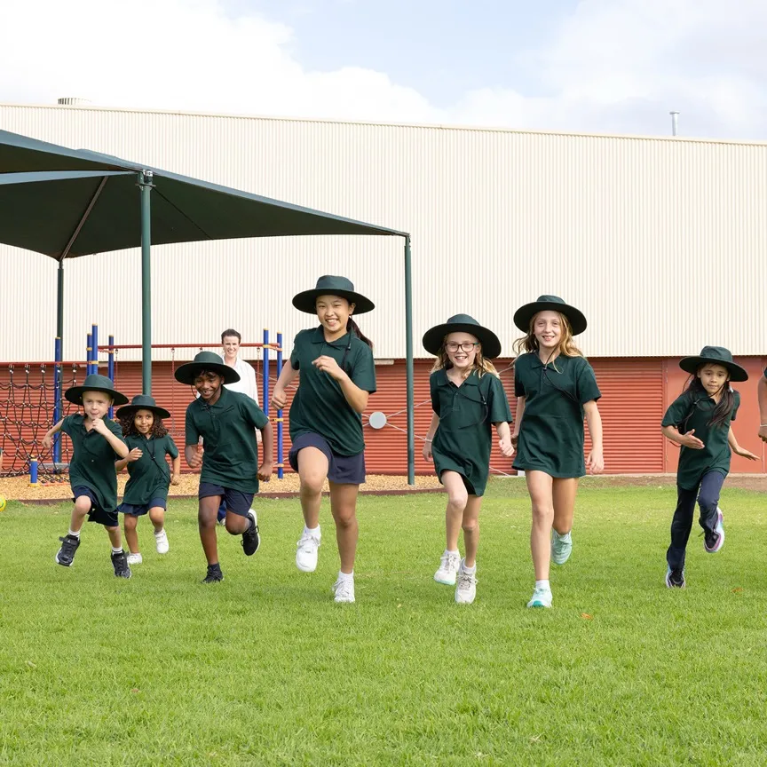 School children running and smiling outdoors