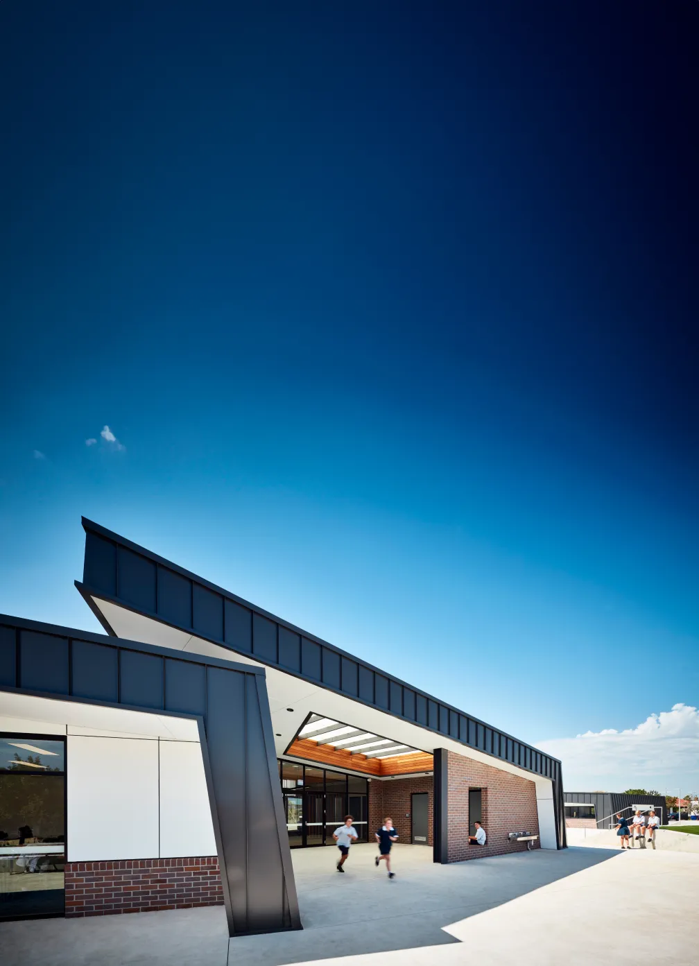 Modern school building with students in courtyard