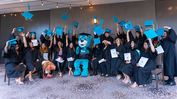 MaKami College graduates with mascot