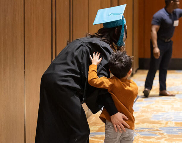 MaKami College graduate hugging her child