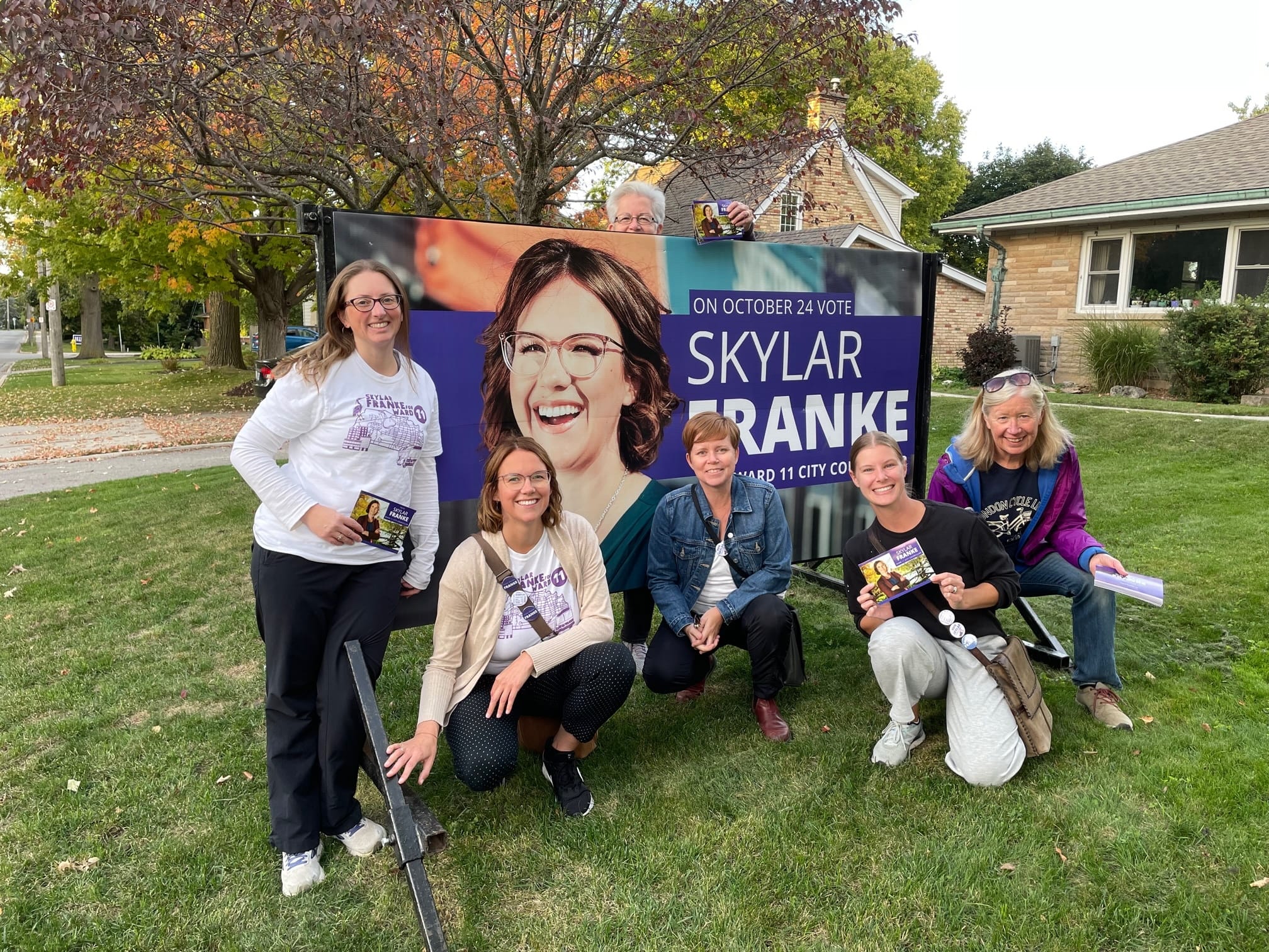 Skylar Franke's campaign billboard with supporters in Ward 11