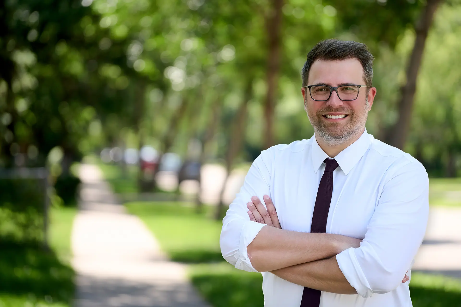 Tyler Crichton standing on a tree-lined St. James street