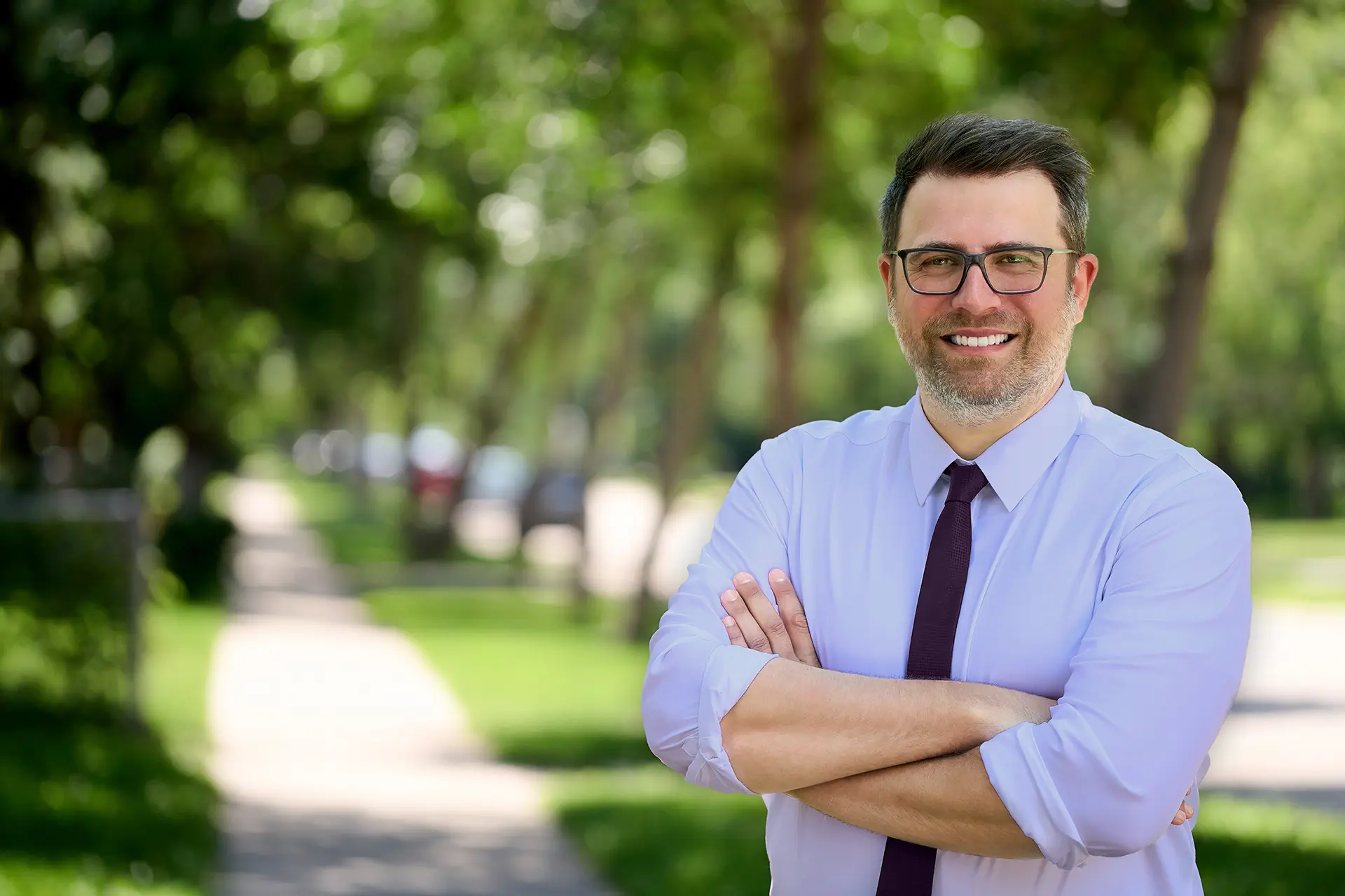 Tyler Crichton standing on a tree-lined St. James street