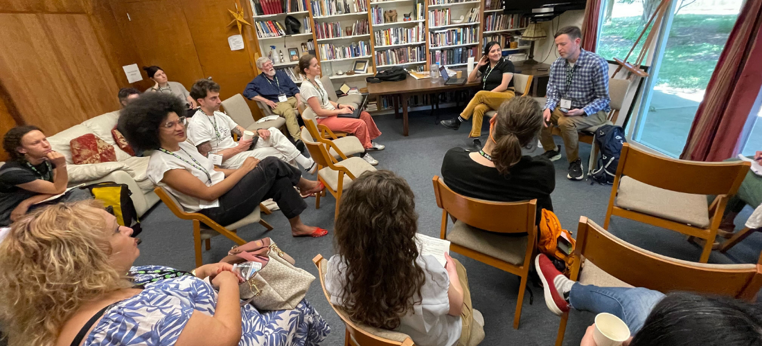 Tobias and Itzel presenting at the 2025 CA Worker Cooperative Conference to a small room full of people.