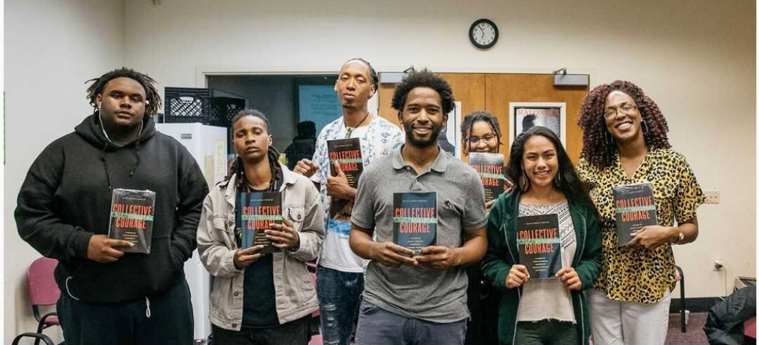 Members of Repaired Nations Book Club holding up the book Collective Courage